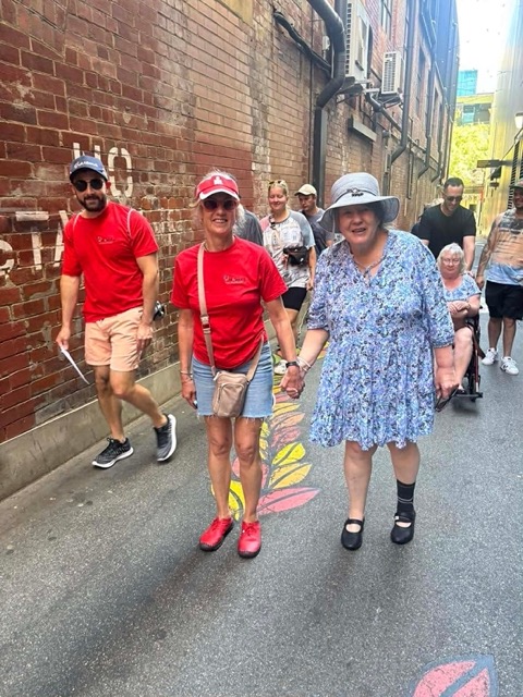 Group Day Events & Programs with OutAbout Oz - A group of ladies walking down the street holding hands